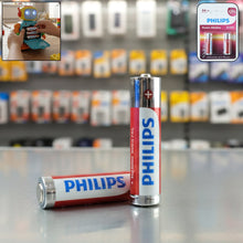 Two AA alkaline batteries from Genzy Store, showing the silver and black packaging for electronic devices.